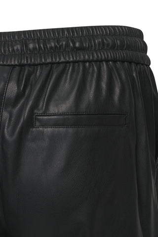 ELLE's Tessa trousers in faux leather, showcasing a drawstring waist for a fashionable and relaxed silhouette.