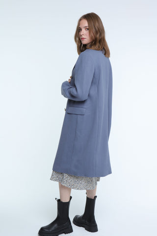 Trendy blue double-breasted long coat, a must-have for a polished look in cooler weather.